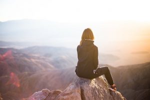 woman sitting on rock